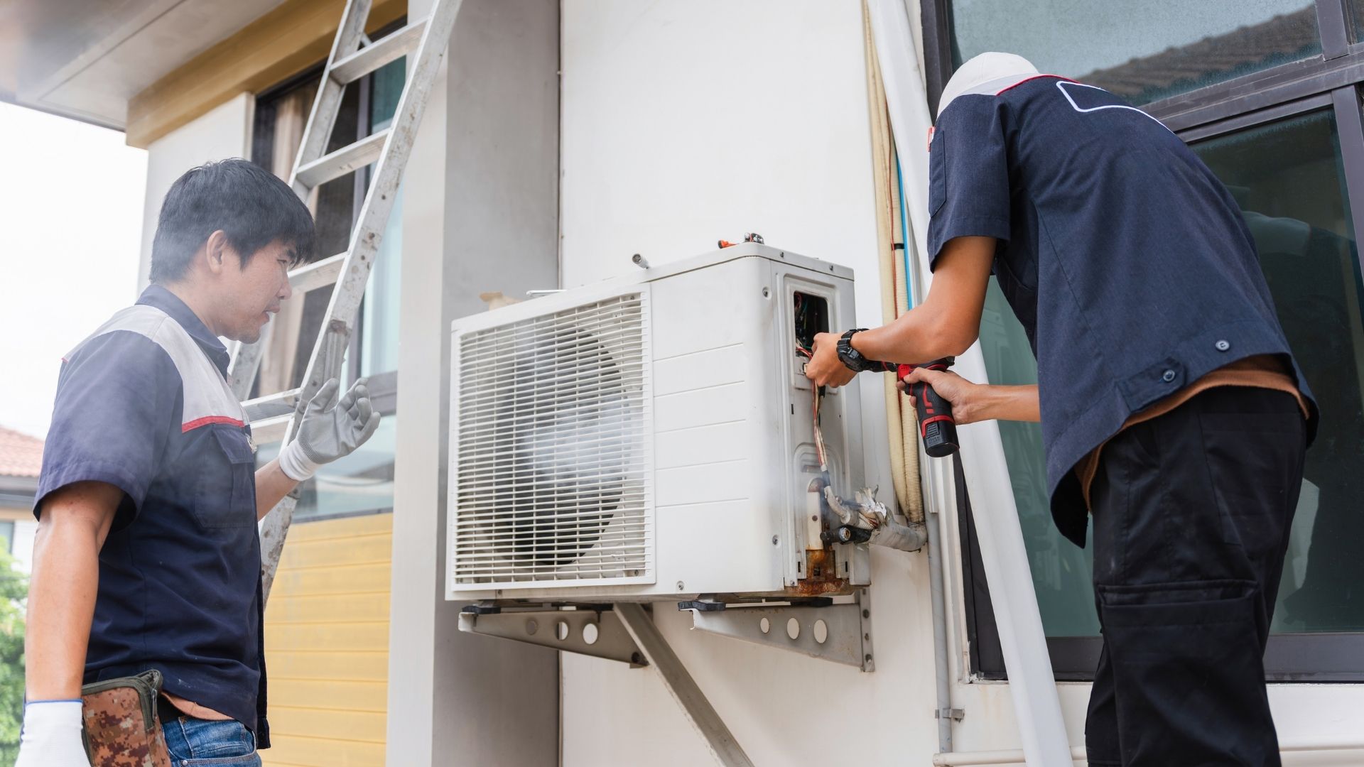 HVAC technician working on outdoor unit in Richmond area